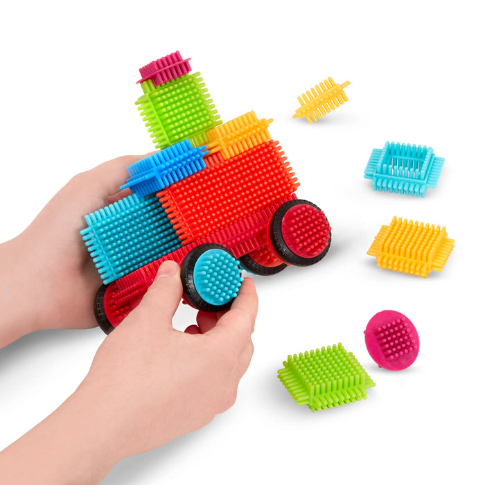 Bristle Blocks laid out in a rainbow pattern.