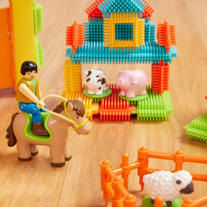 A 67-piece building block set with a farm theme, the set is laid out to show all the pieces, including animals, trees, and tractor.