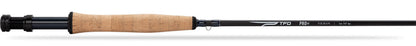 Fishing rod with cork handle and black grip on a white background
