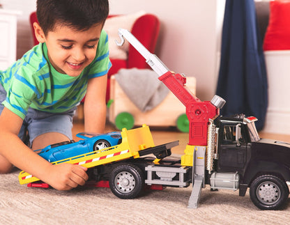 Black toy tow truck towing blue car